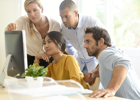 business team working together on desktop